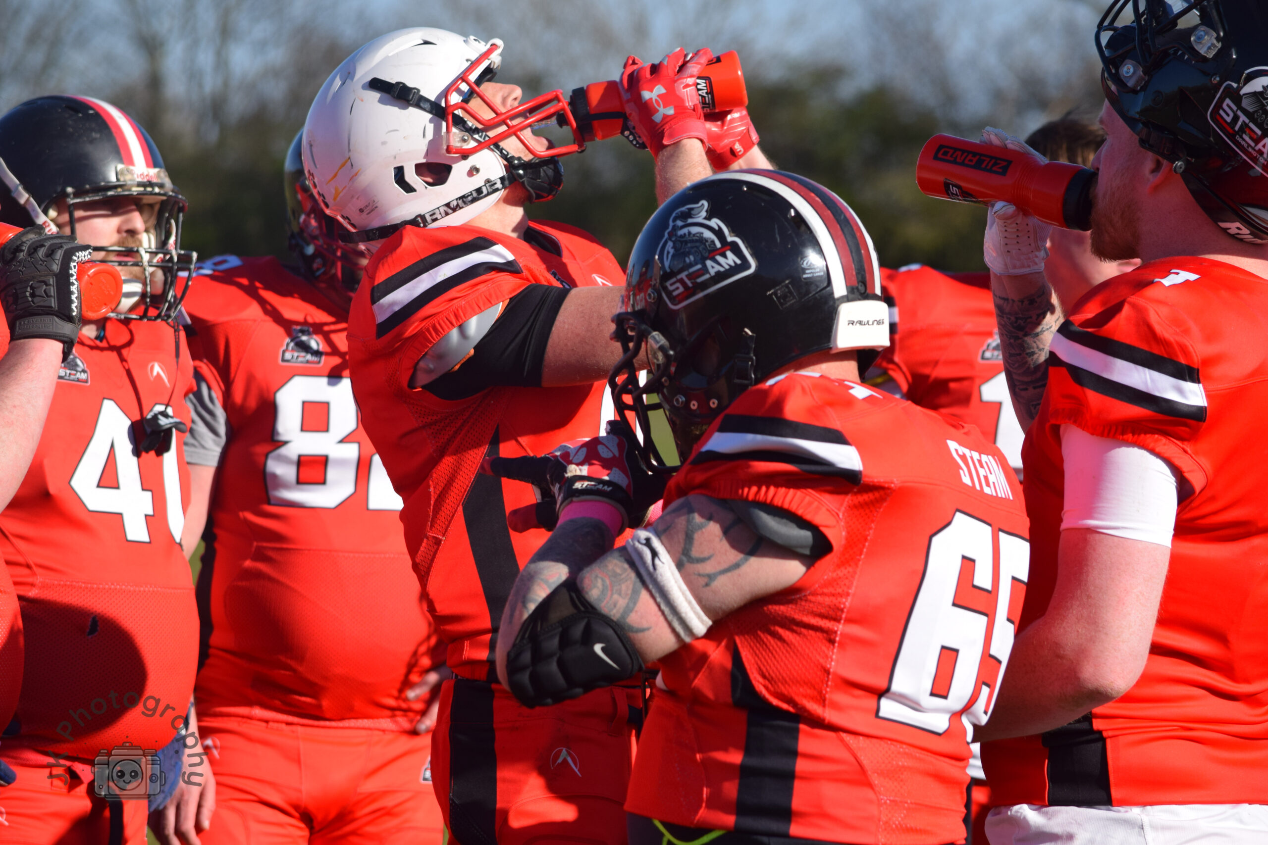 American Football Player Drinking Water Through Helmet. Darlington Steam American Football Club
